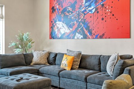 Deep gray sectional under a burst of bold color gallery-sized art