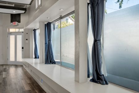 Floor-to-ceiling windows with dramatic blue drapes