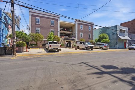 Welcoming building entrance w/ lush greenery