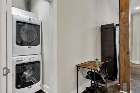 Laundry and a work desk tucked side by side