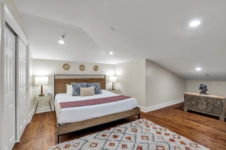 Rustic wood headboard under a vaulted ceiling