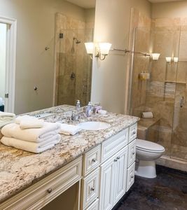 Spa-like bathroom w/ stone tile shower & granite vanity