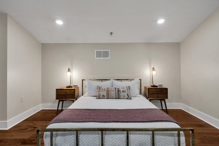 Tufted gray headboard with walnut nightstands