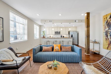 Stylish open living with exposed beams and modern flair