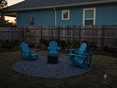 Vibrant outdoor seating w/ Adirondack chairs on a blue rug — made for lazy afternoons.
