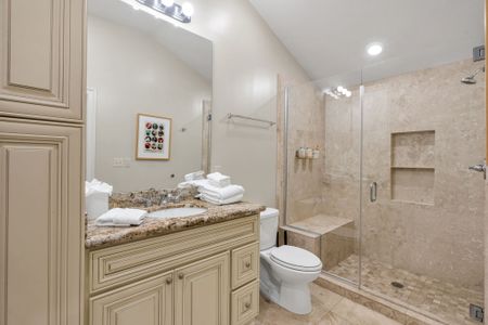 Framed art and granite in a sparkling bath