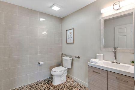 Bright tiled bath with a calm, clean feel
