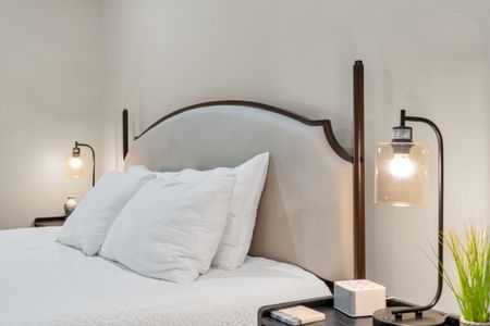 Curved upholstered headboard with sconce lighting