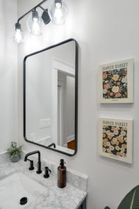 Do a quick outfit check in the full-length mirror next to cheerful floral art