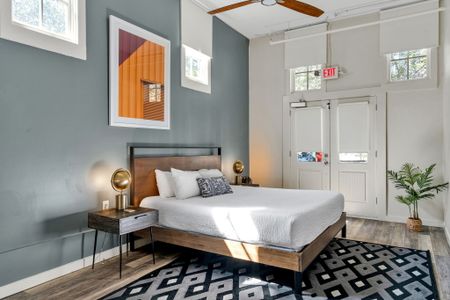 Iron and wood bed under vibrant orange art