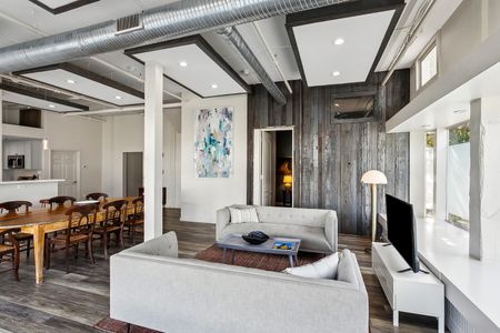 Cozy living space w/ sofa, art & wood-plank accent wall.