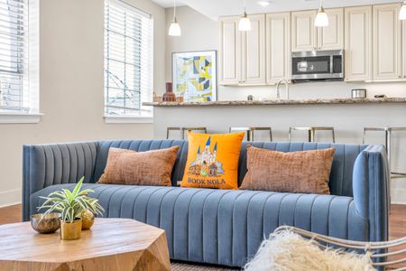 Plush blue sofa with a little Book NOLA welcome
