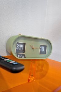 Fun retro flip clock & TV remote close at hand on the bright nightstand