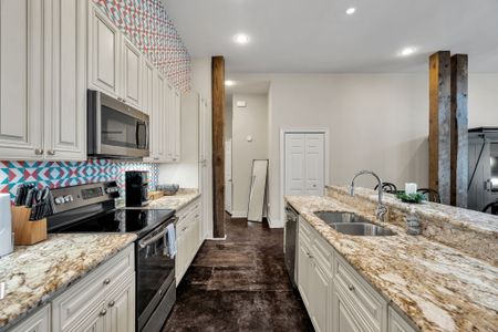 Galley kitchen with exposed wood beam