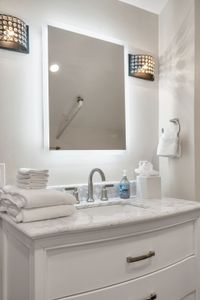 Backlit mirror and fluffy towels at the ready