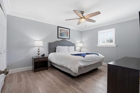 Bright king bedroom w/ ceiling fan & soft tones for easy, restful nights.