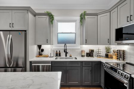 Rinse up by the sunny window over the sink, surrounded by fresh greenery & gray cabinetry
