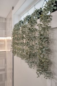 A lush wall of greenery brings a fresh, calming touch to the bathroom
