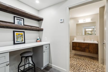 Cute vanity nook w/ sink, wood shelving & décor touches.