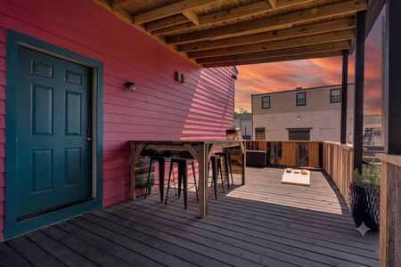 Colorful deck w/ bar seating & cornhole — your go-to spot for laid-back hangs.