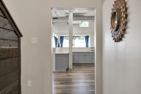 Hallway peek into the bright kitchen