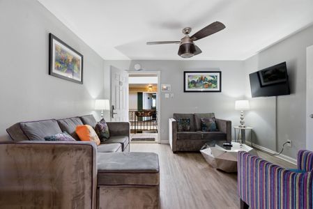 Bright living room w/ comfy seating & warm décor — the perfect spot to unwind after a day out.
