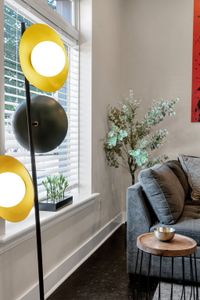 Mod floor lamp beside a sunny window