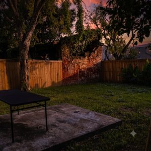 Sunny outdoor patio w/ a table — perfect for soaking up that New Orleans warmth.