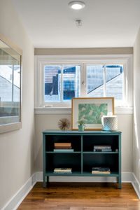 Sunny window nook with a teal bookshelf