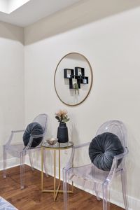 Velvet chairs and a playful round shelf