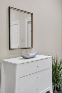 Crisp white dresser with sculptural accents