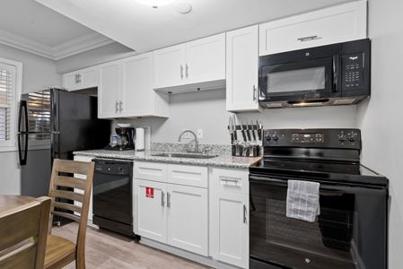Unit 206 fully equipped kitchen & dining area for easy, relaxed meals.
