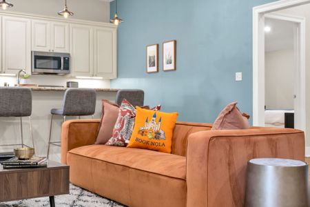 Book NOLA pillows on a cozy orange sofa