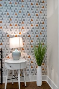 Geometric wallpaper and a soft glowing lamp