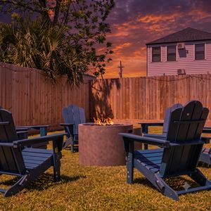 Cozy backyard firepit surrounded by Adirondack chairs — perfect for a NOLA evening under the stars.