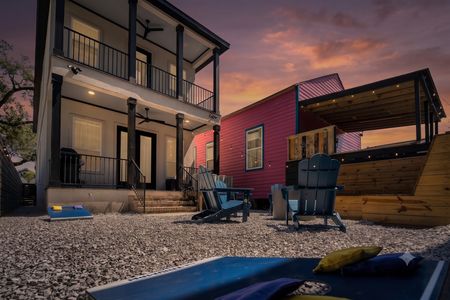 Backyard setup w/ cornhole, firepit & colorful surroundings for the whole group.