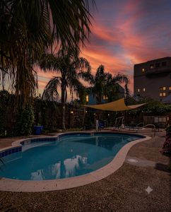 Take a dip in the sparkling community pool surrounded by swaying palms on a sunny day.