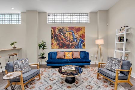 Velvet sofa beneath a jazzy saxophone mural