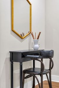 Gold hexagon mirror over a sleek vanity desk