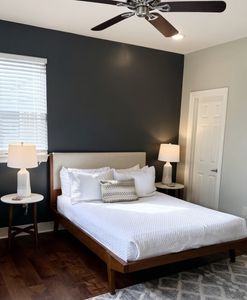 Cozy bedroom w/ bed & warm hardwood floors