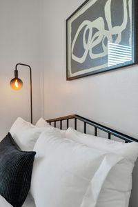 Sink into plush pillows & read by the warm glow of the wall lamp before bed