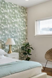 Bedside lamp beneath a breezy palm print