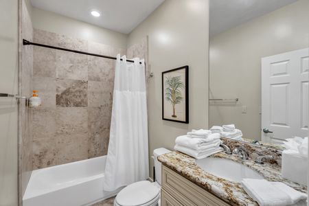 Bright full bath with tub and fresh towels