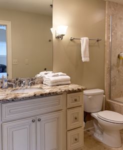 Elegant bathroom w/ double vanity & stone finish
