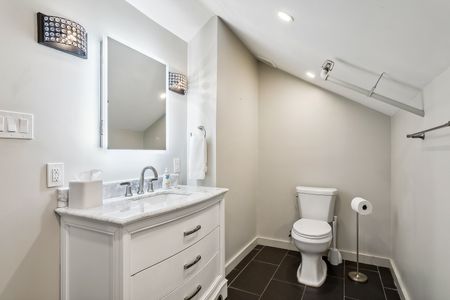 Clean bathroom w/ sink & toilet.
