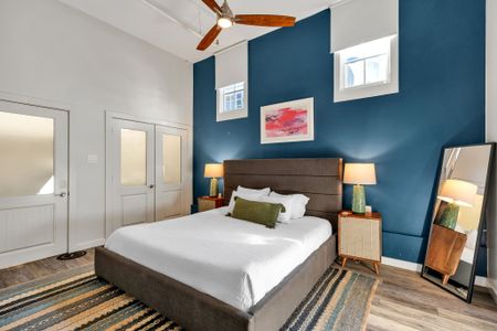 Navy accent wall with warm wood and pops of pink