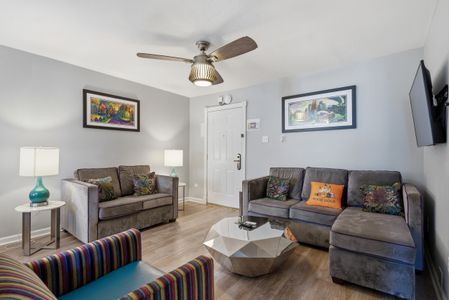Bright living area w/ cozy seating & a welcoming, airy feel.