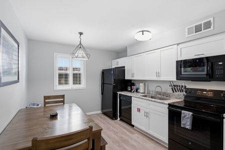 Unit 205 kitchen w/ clean white finishes, ready for home cooking.