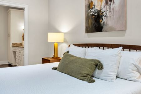 Sage pillows and a warm bedside lamp