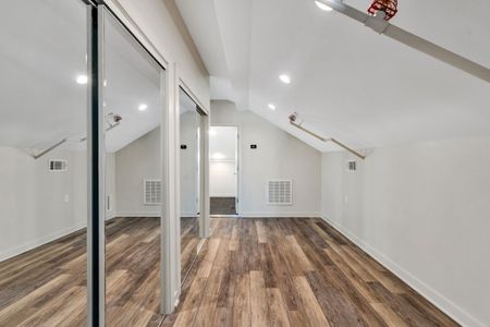 Vaulted loft space with mirrored closets